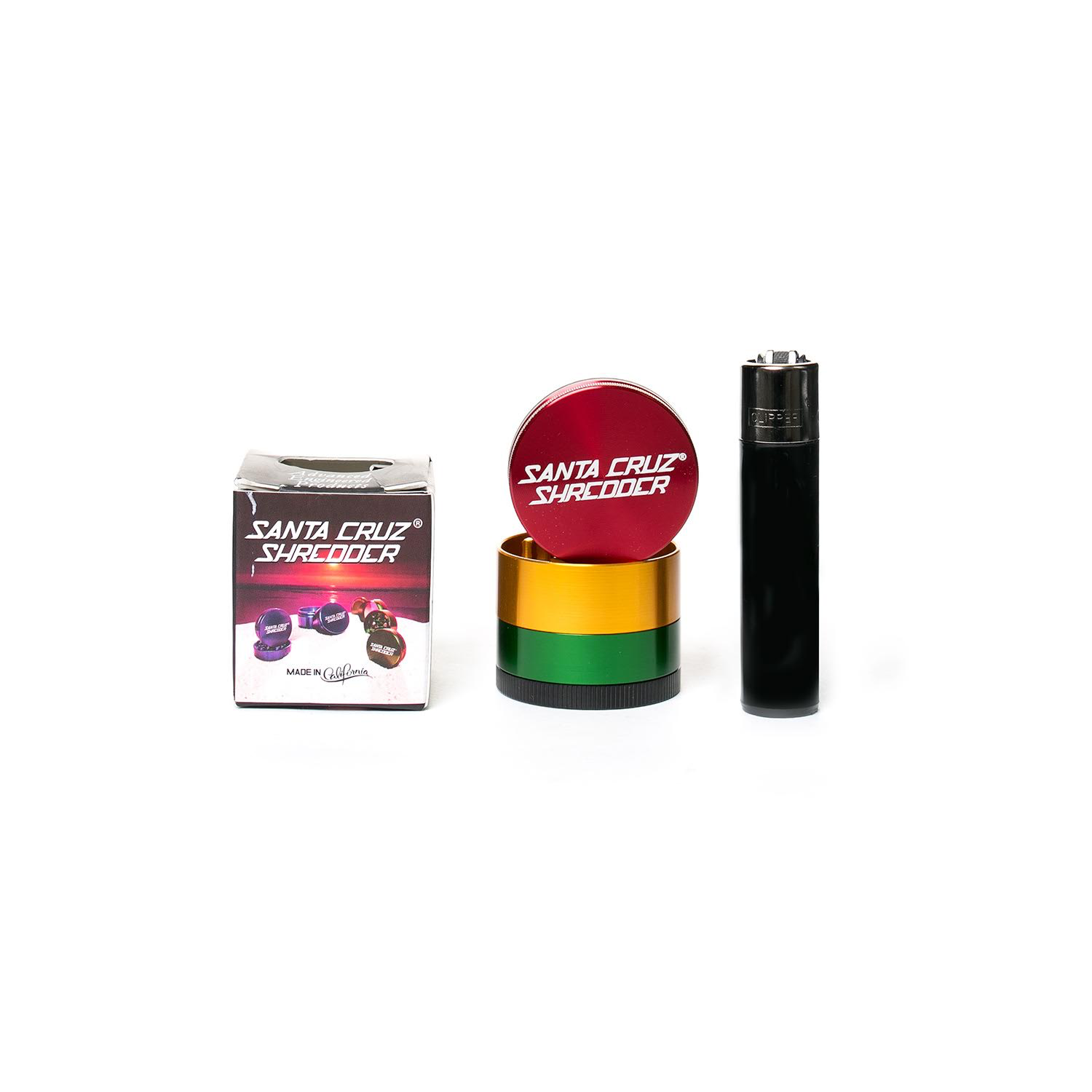 Santa Cruz Shredder 4-Piece Small - Rasta With Clipper Lighter for scale